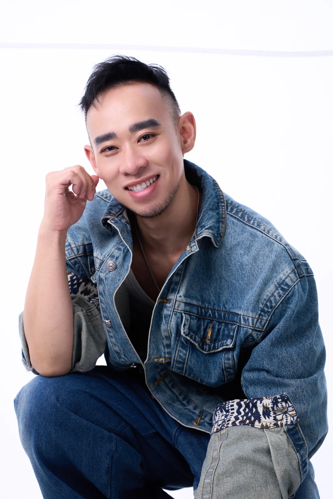 Kane Diep smiling in a denim jacket